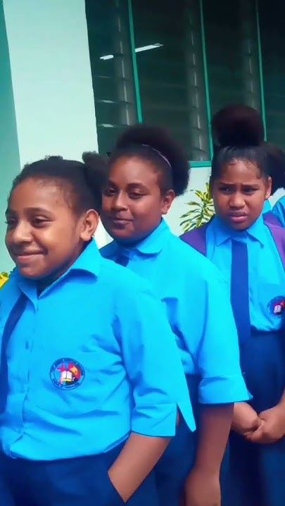 PMCA students in school uniform standing together outside a classroom