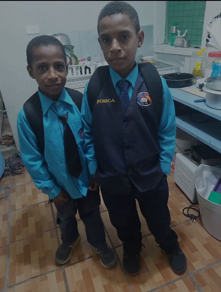 PMCA students in school uniform standing together inside a classroom